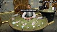 Live Blackjack Madrid table with dealer waiting for next round of hands.