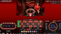 Live dealer Roulette Macao table showing winning number 36 red in a red studio..